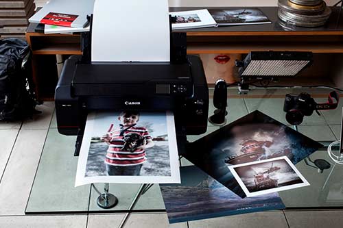 A black Canon printer prints high-quality photos
