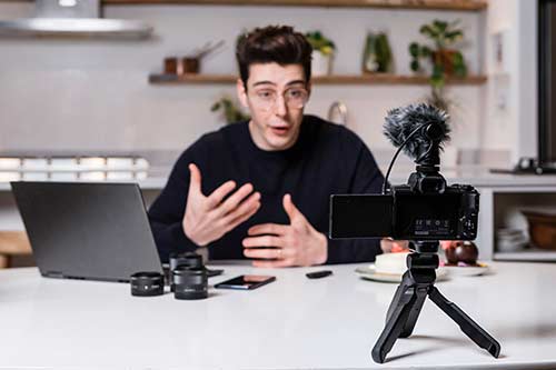 Man explaining something extensively in front of the camera with gestures.