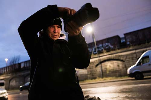 Photographer photographing in the city in low light