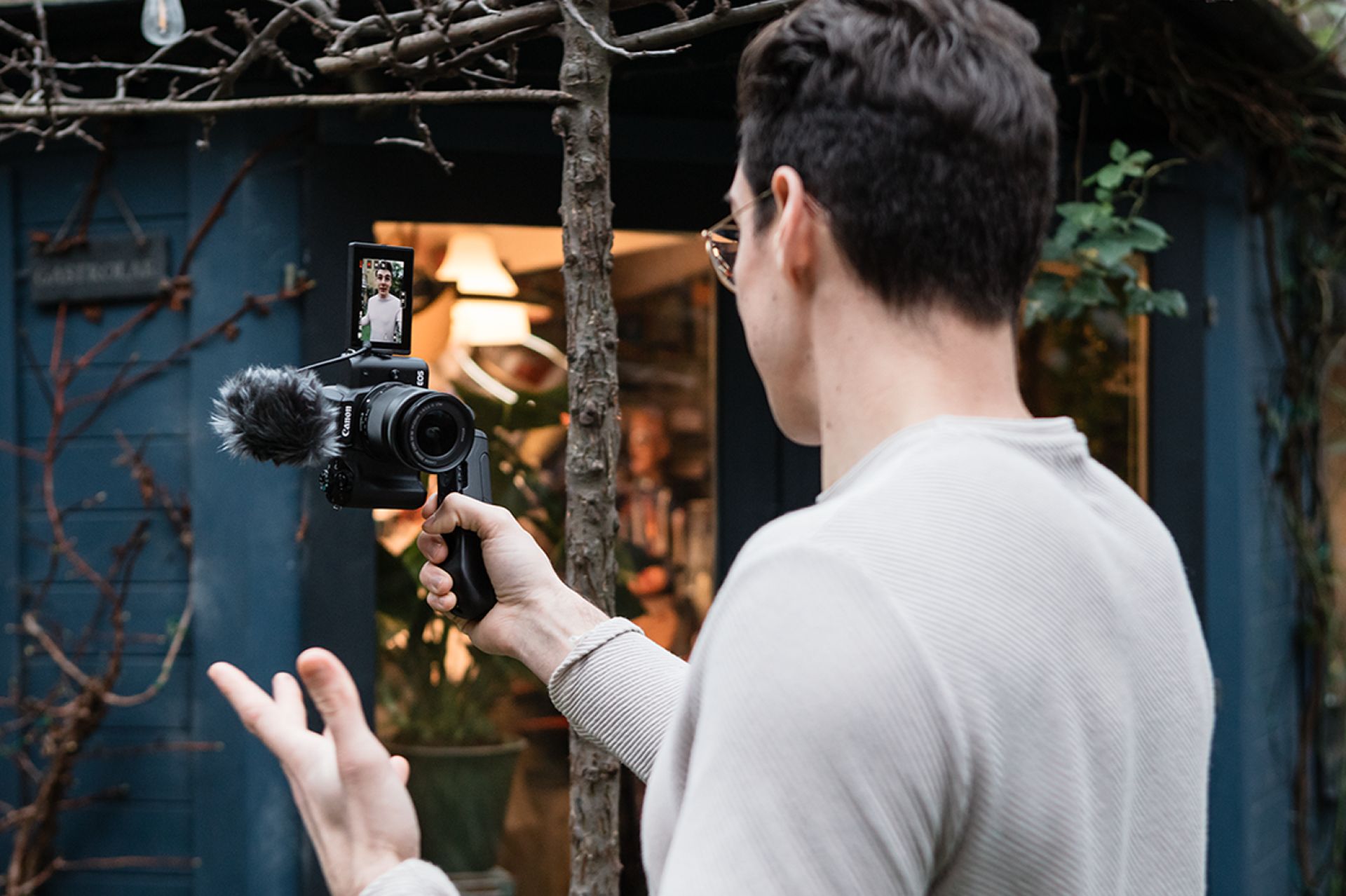 Man taking a video of himself with a Canon Camera